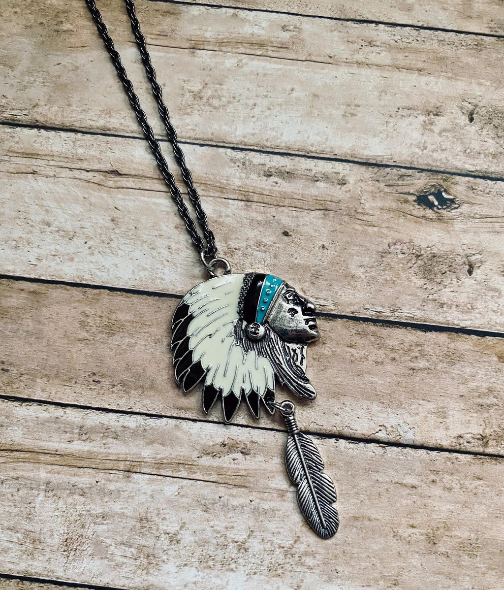 Necklace with a Native American headdress pendant on a wooden surface