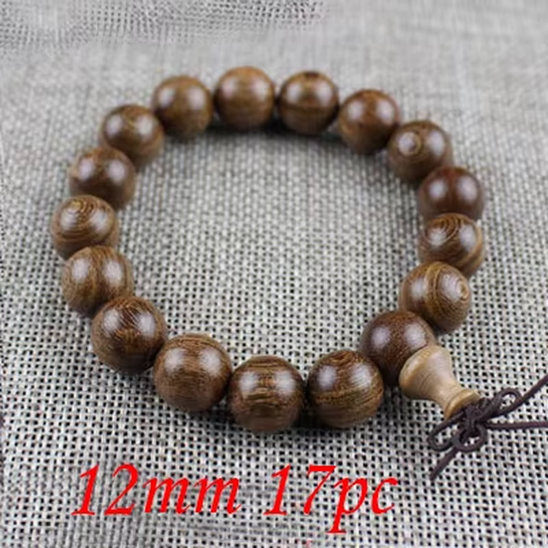 Wooden beaded bracelet with 12mm beads on a textured fabric background