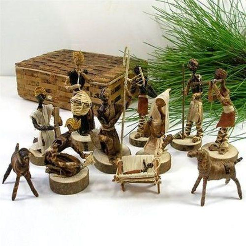 Wooden nativity scene set with figures and animals on a white surface.